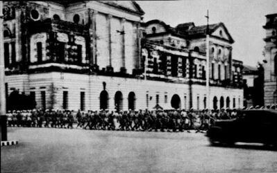 Singapore - German sailors march along Connaught Drive.
1945. 250 Germans including the Crews of U-boats 181 & 862 are marched along Connaught Drive. They kept spirits up by whistling and singing and marching in formation. They were later used by the British to carry out repairs to the Naval Base and Singapore. Photo compliments of Dieter Hille Chief Engineering Officer of U-181. Dieter and a few of his crew were picked by the Royal Engineers to repair an Ice Making Factory in Singapore. They succeeded after which Japanese PoW's were used to manhandle the ice.
