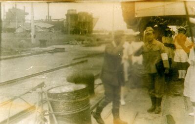 Singapore Naval Base - Japanese Occupation. HMS Rotherham takes surrender
1945. September 6th. Captain of HMS Rotherham H W Biggs D.S.O.; R.N. sailed into Singapore Naval Dockyard and took the formal surrender of the Japanese 10th Zone Fleet. Although the dockside was deserted with just a small Japanese party to agree the surrender they found 34,000 Japanese on the base. 'Rotherham Gate' was named in honour of this event. Photo compliments of the HMS Rotherham Association.(Possibly now dissolved)  
