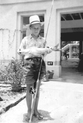 Singapore Naval Base - Fishing in the Dockyard
1960.  Peter after a day’s fishing on Beaulieu Pier. Here with large Ikan Duri (Cat fish).
