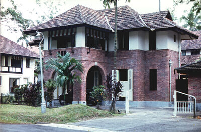 Naval Base Housing
1969. One of the detached residences (No 101) on Wellington Road allocated to civilian staff posted to Singapore. These overlooked the Dockyard Swimming Pool (now called The Terror Club) and the football pitch. Different from the regular 'Black & Whites' as these had living accommodation on the ground floor and bedrooms upstairs. Note the cowboy style swing doors downstairs and the drop down cane blinds (we called them chiks) upstairs. All to aid ventilation and cooling of the property.  
